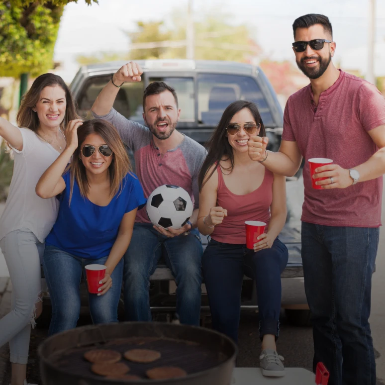 People with red cups and soccer ball