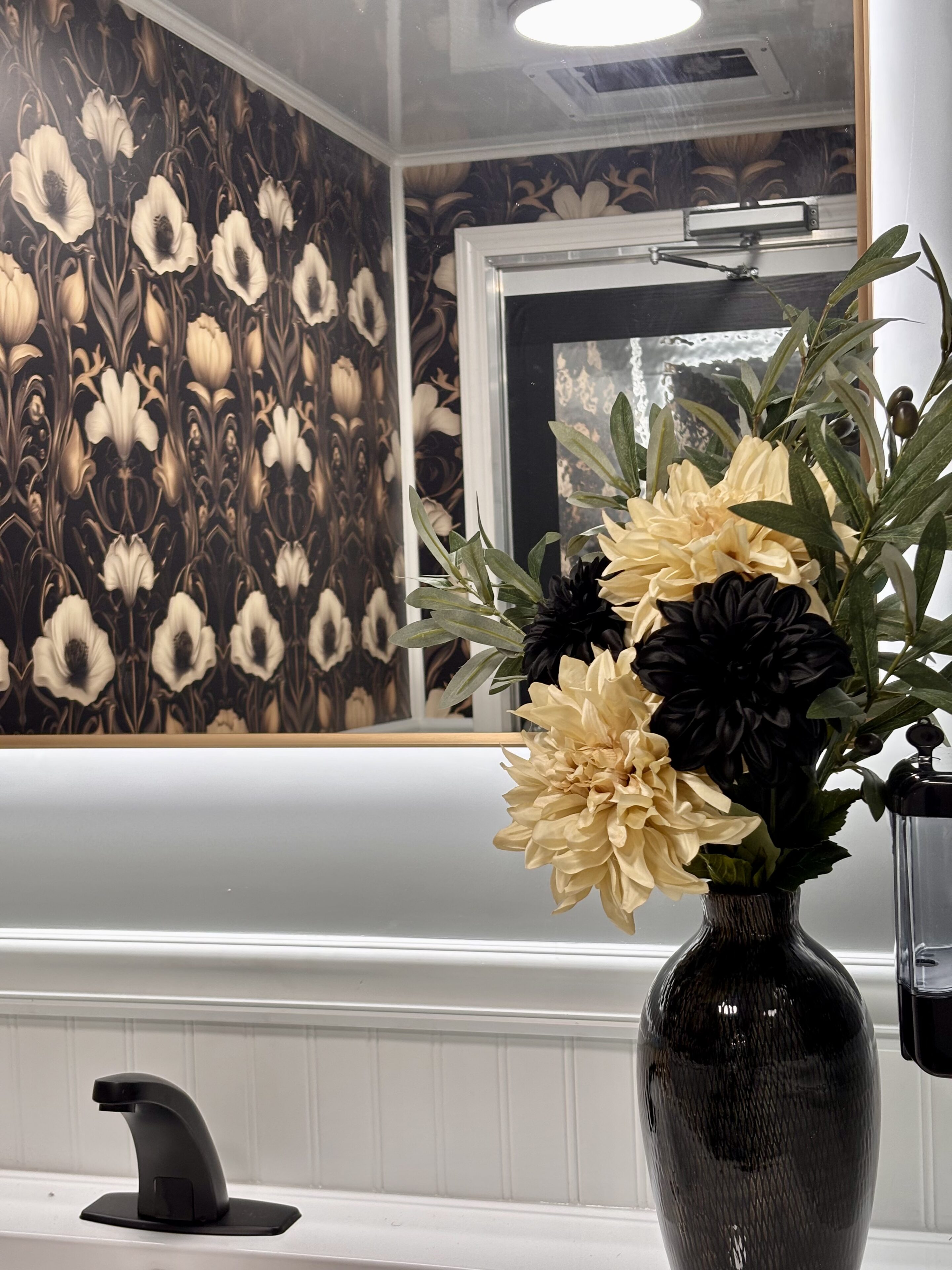 Black vase with yellow and black flowers